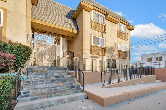 a utility room with dryer washer and a view of kitchen