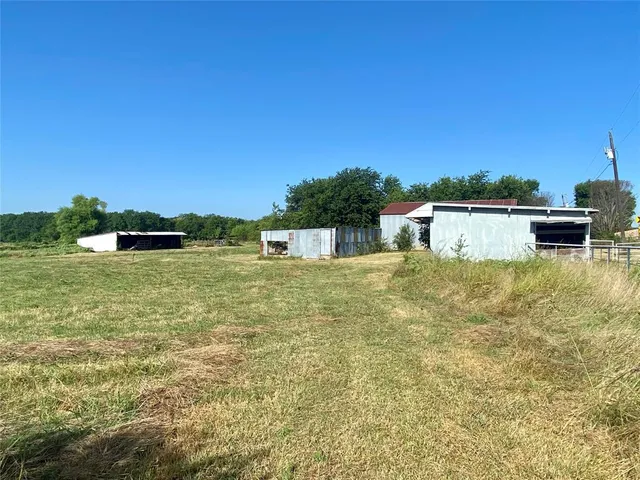 a swimming pool with trees in the background