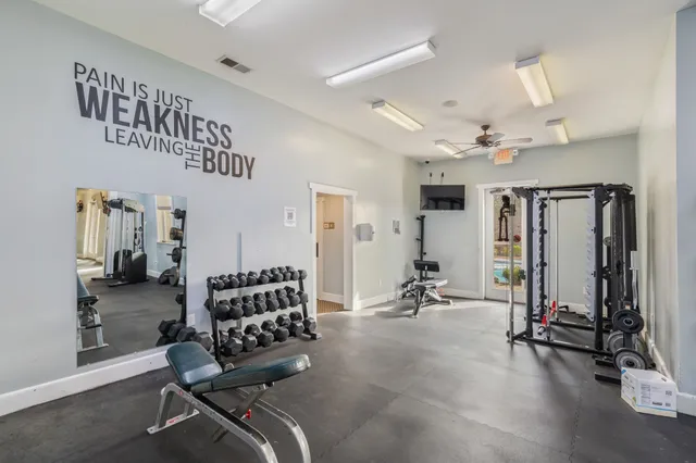 a living room with furniture a flat screen tv and a large window