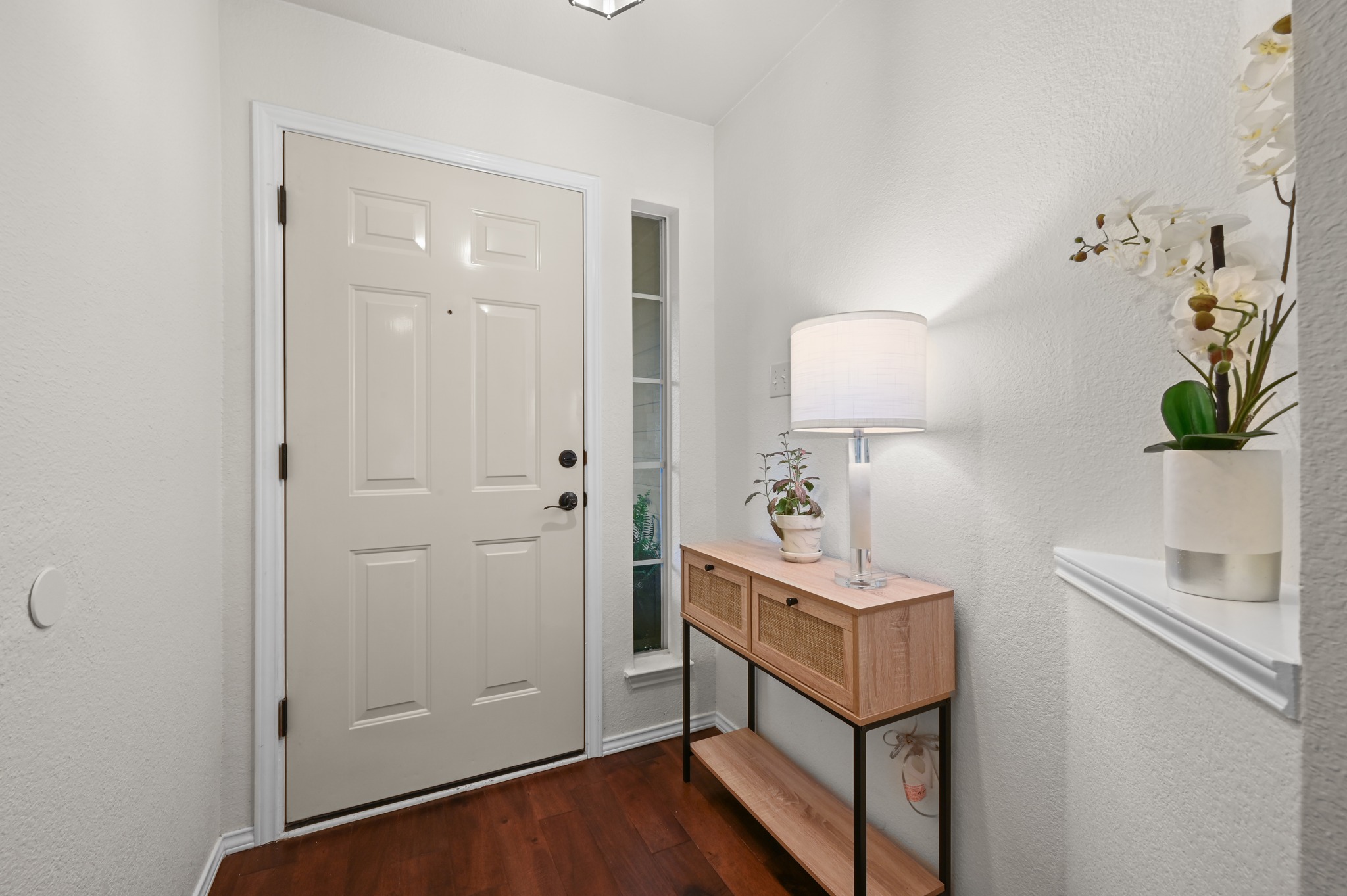 1409 Knoll Ridge Drive Cedar Park, TX 78613 - Photo 7 of 30 A welcoming entryway with a modern console table and rich hardwood flooring sets a refined tone.