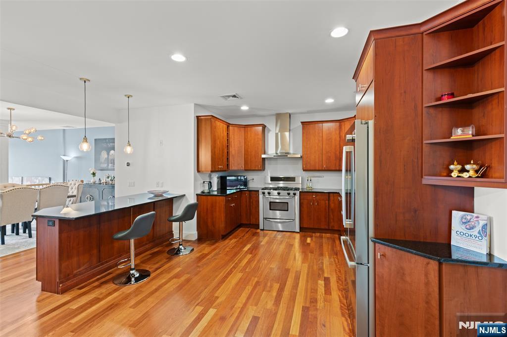 7 Oakdene Terrace, Unit 7 Edgewater, NJ 07020 - Photo 14 of 30 a large kitchen with stainless steel appliances kitchen island granite countertop a large cabinets a sink and a counter space