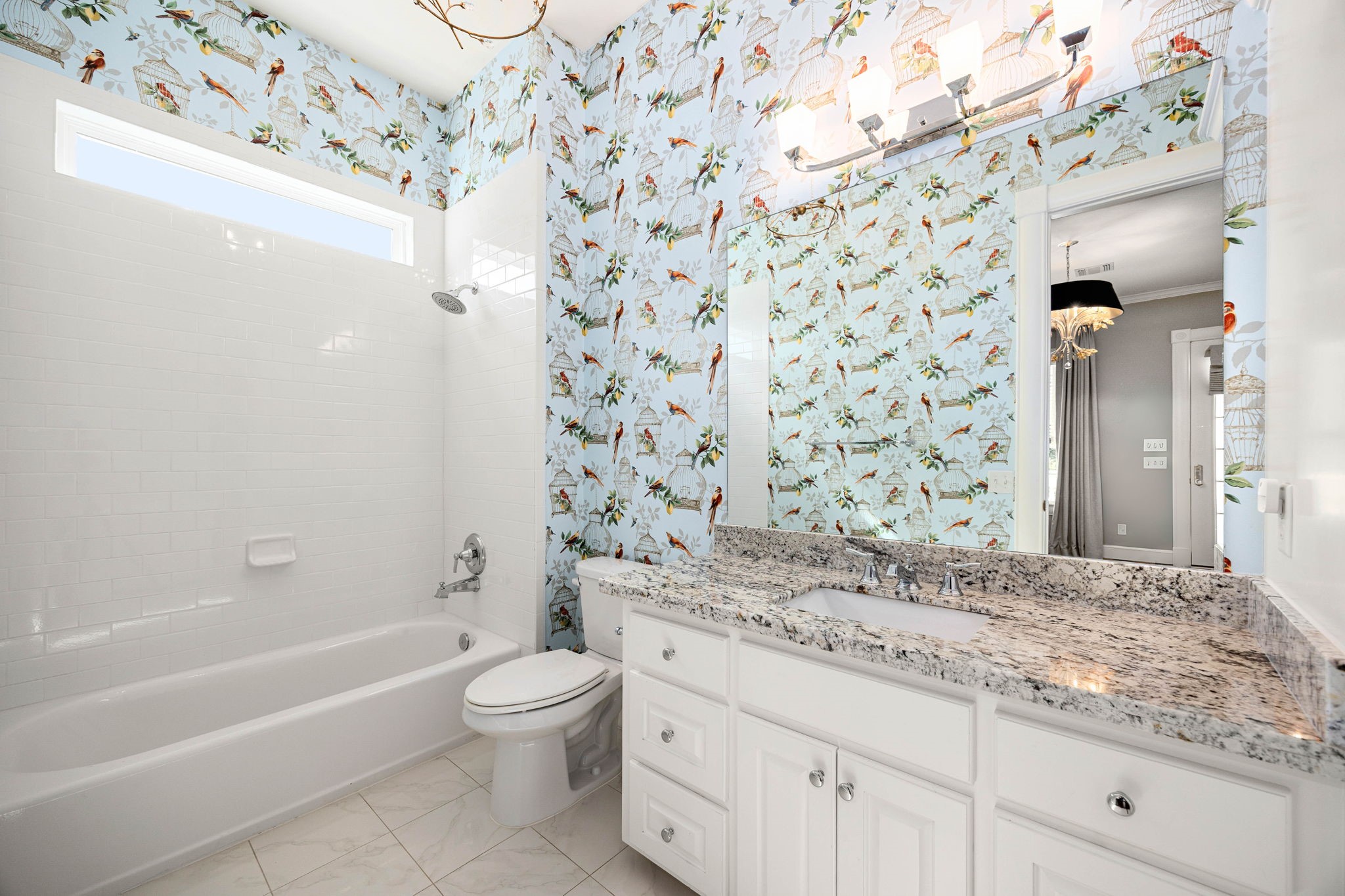 6039 Franz Road Katy, TX 77493 - Photo 29 of 49 Playful bird-and-birdcage wallpaper brings personality to this ensuite bath, balanced by a granite vanity and full tub/shower for both style and function.