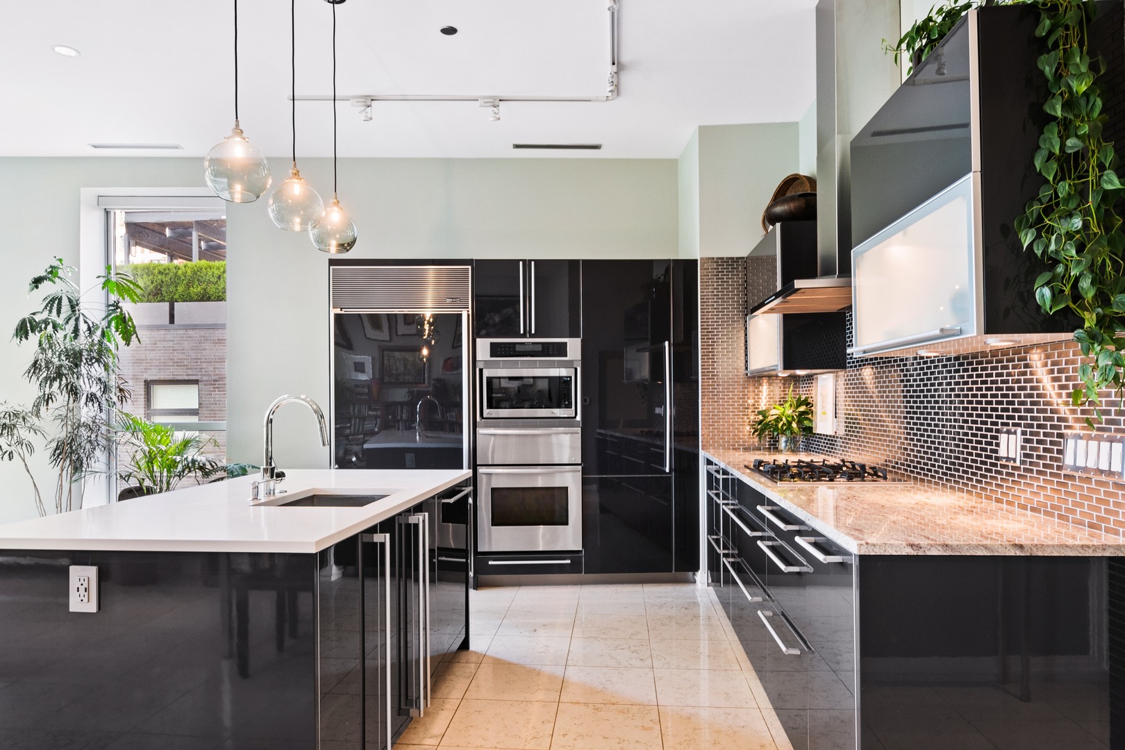 30 West Oak Street, Unit 5E Chicago, IL 60610 - Photo 8 of 22 a kitchen with stainless steel appliances granite countertop a sink and a stove
