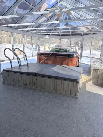 a view of a room with wooden floor and windows