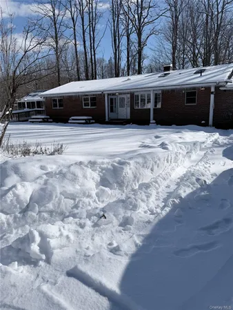 a view of a house with a snow in front of it