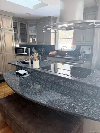 a kitchen with stainless steel appliances granite countertop a sink stove and refrigerator