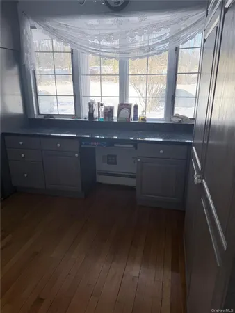 a kitchen with a sink a window and cabinets