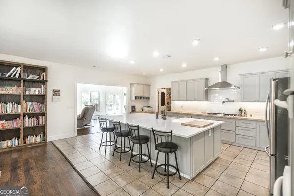 a living room with furniture wooden floor and a large window