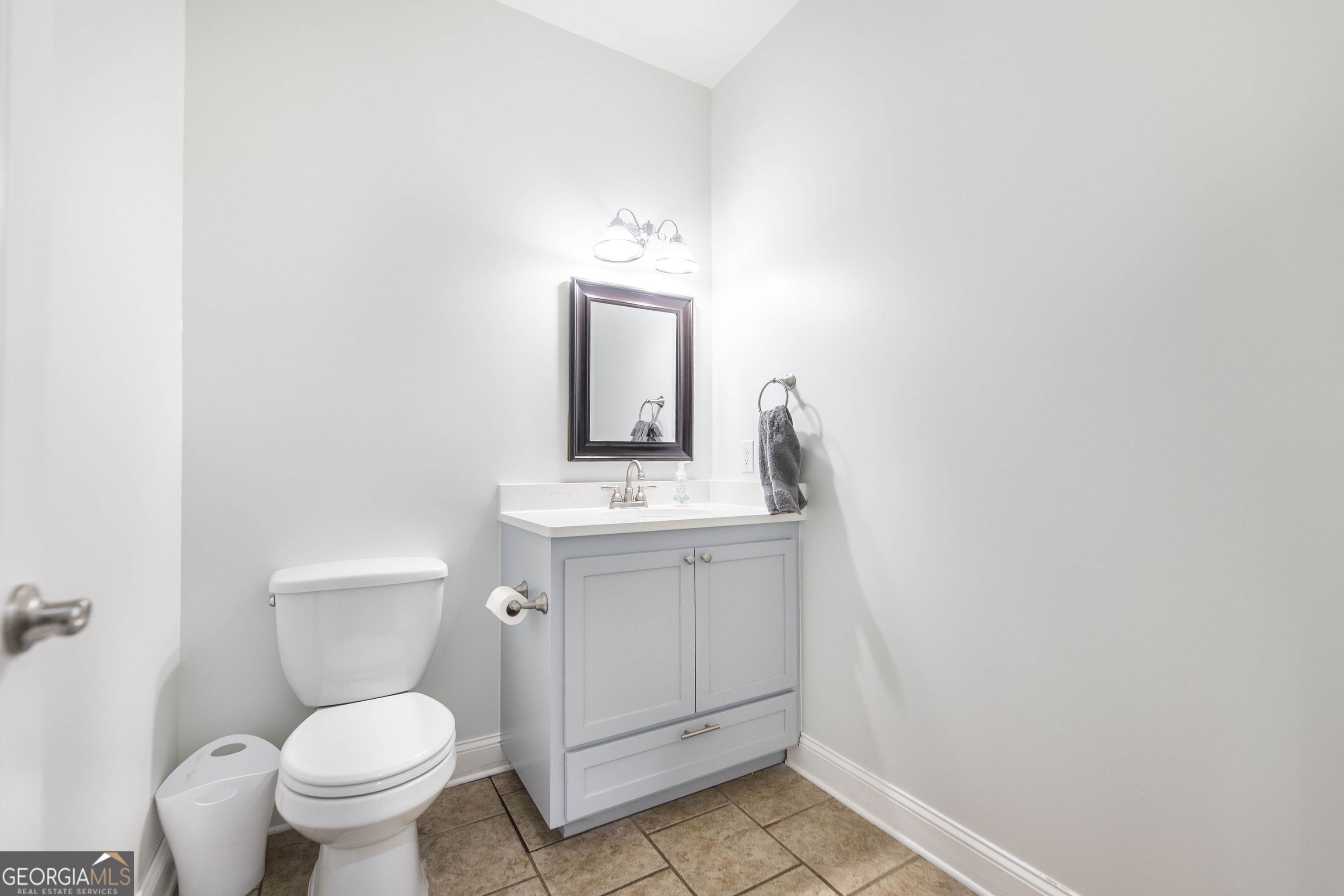 1979 Dent Road Musella, GA 31066 - Photo 19 of 77 a bathroom with a toilet sink and mirror