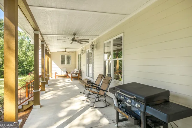a large white kitchen with kitchen island a stove a sink a refrigerator and cabinets