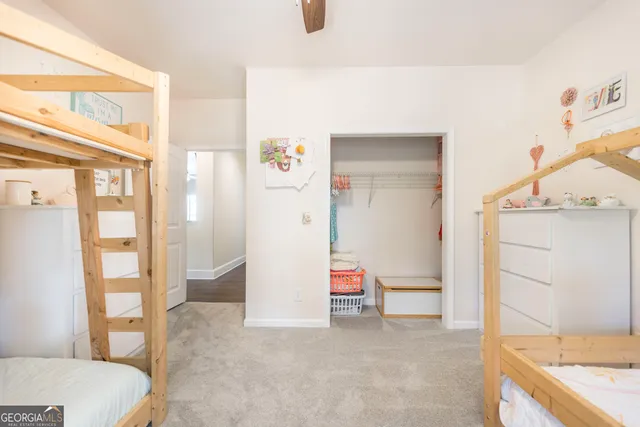 a view of a house with big yard and a large tree