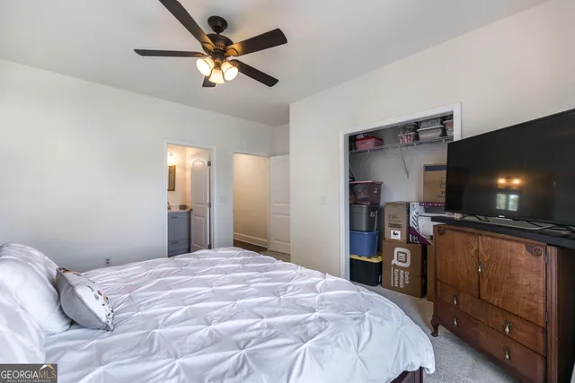 a view of a green field with trees in the background