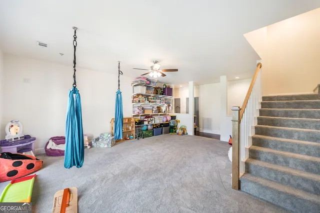 a view of a big yard with plants and large trees