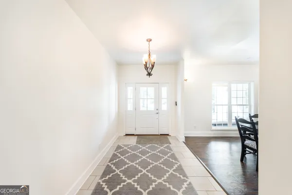 a kitchen with white cabinets and appliances