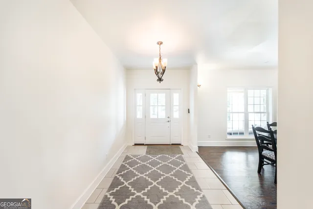 a kitchen with white cabinets and appliances