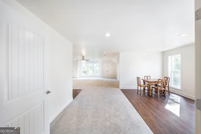 a view of a lush green forest with trees and some houses
