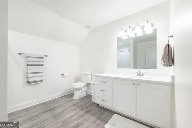 a view of a lush green forest with trees and some houses