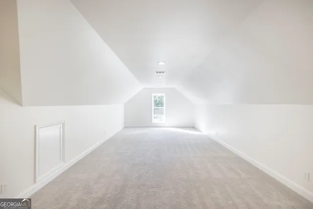 a view of a house with a big yard potted plants and large tree