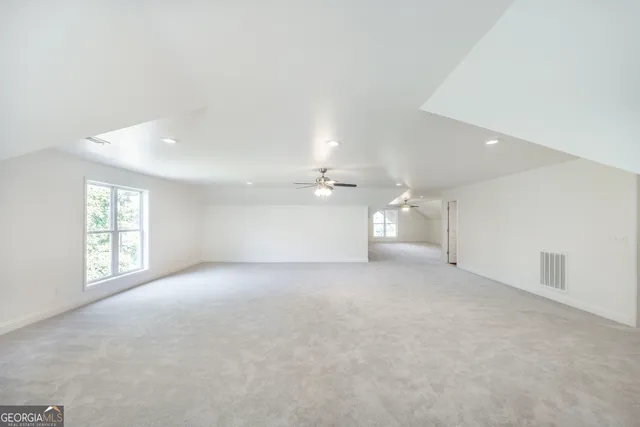 a view of a house with backyard and trees