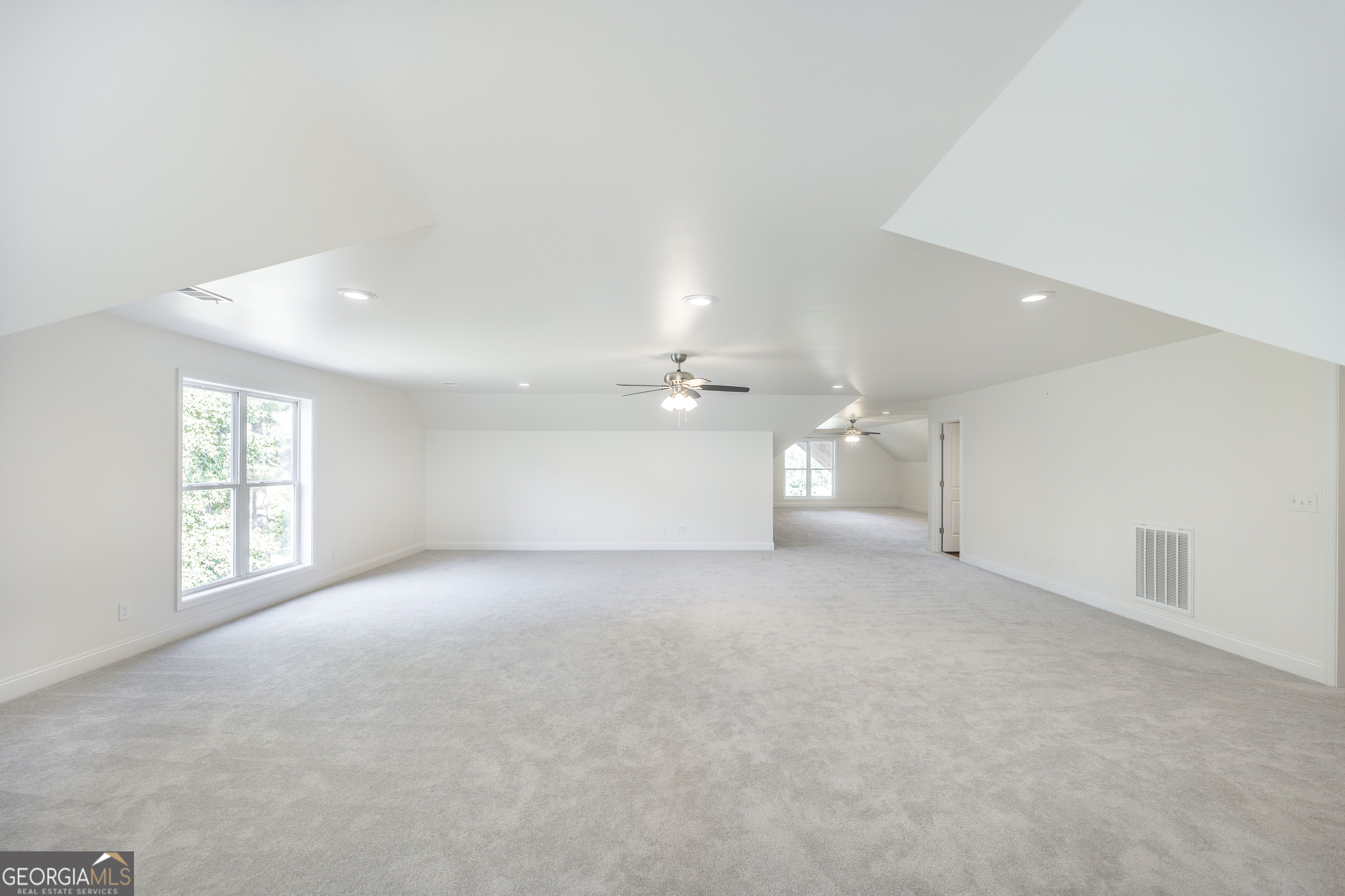 1979 Dent Road Musella, GA 31066 - Photo 45 of 77 an empty room with windows and chandelier fan