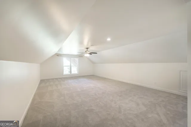 a view of a house with a yard and large tree