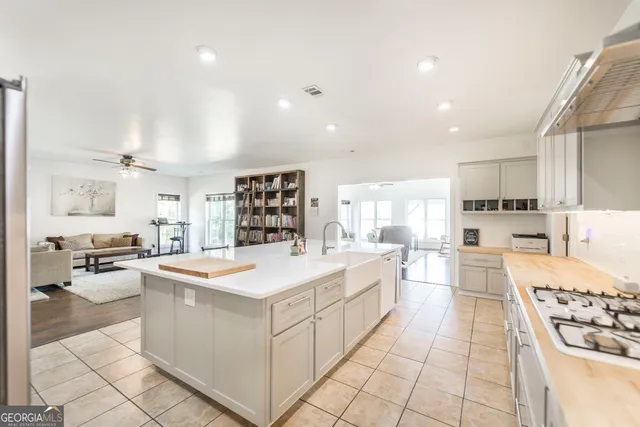 a kitchen with stainless steel appliances kitchen island granite countertop a sink and cabinets