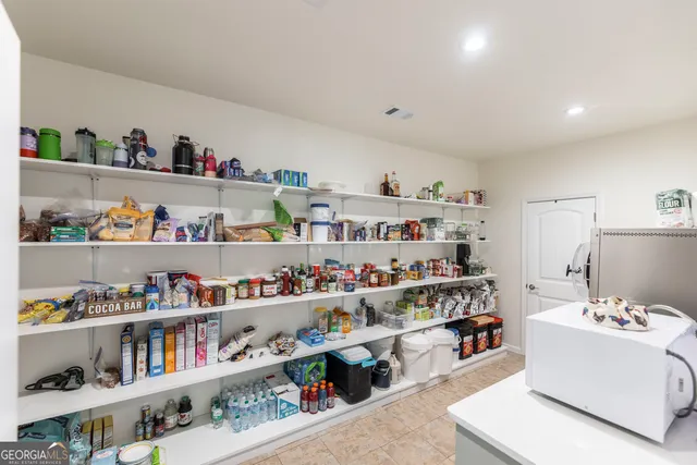 a living room with furniture and a book shelf