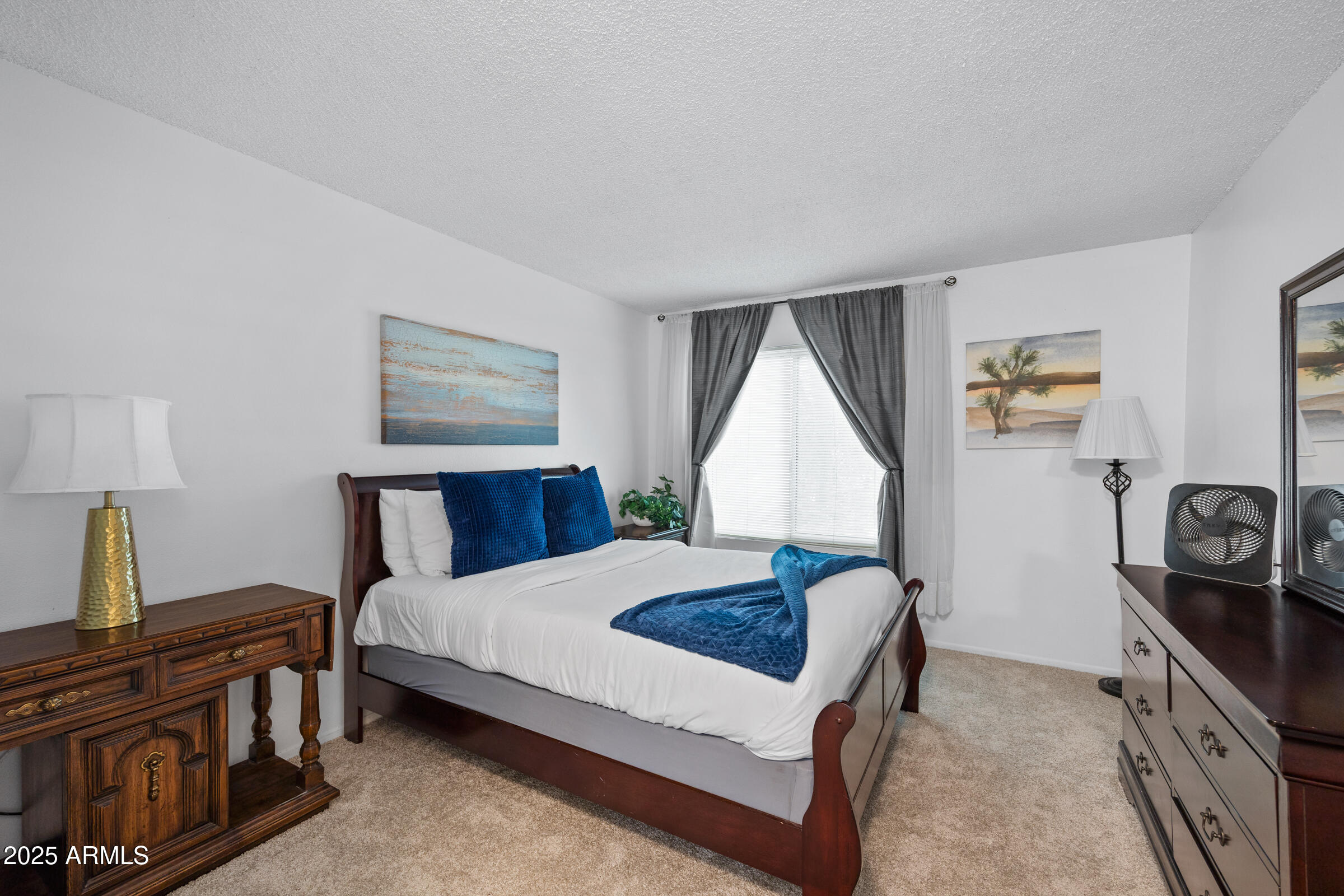 5525 East Thomas Road, Unit M11 Phoenix, AZ 85018 - Photo 10 of 39 a bedroom with a bed and a stove next to a window