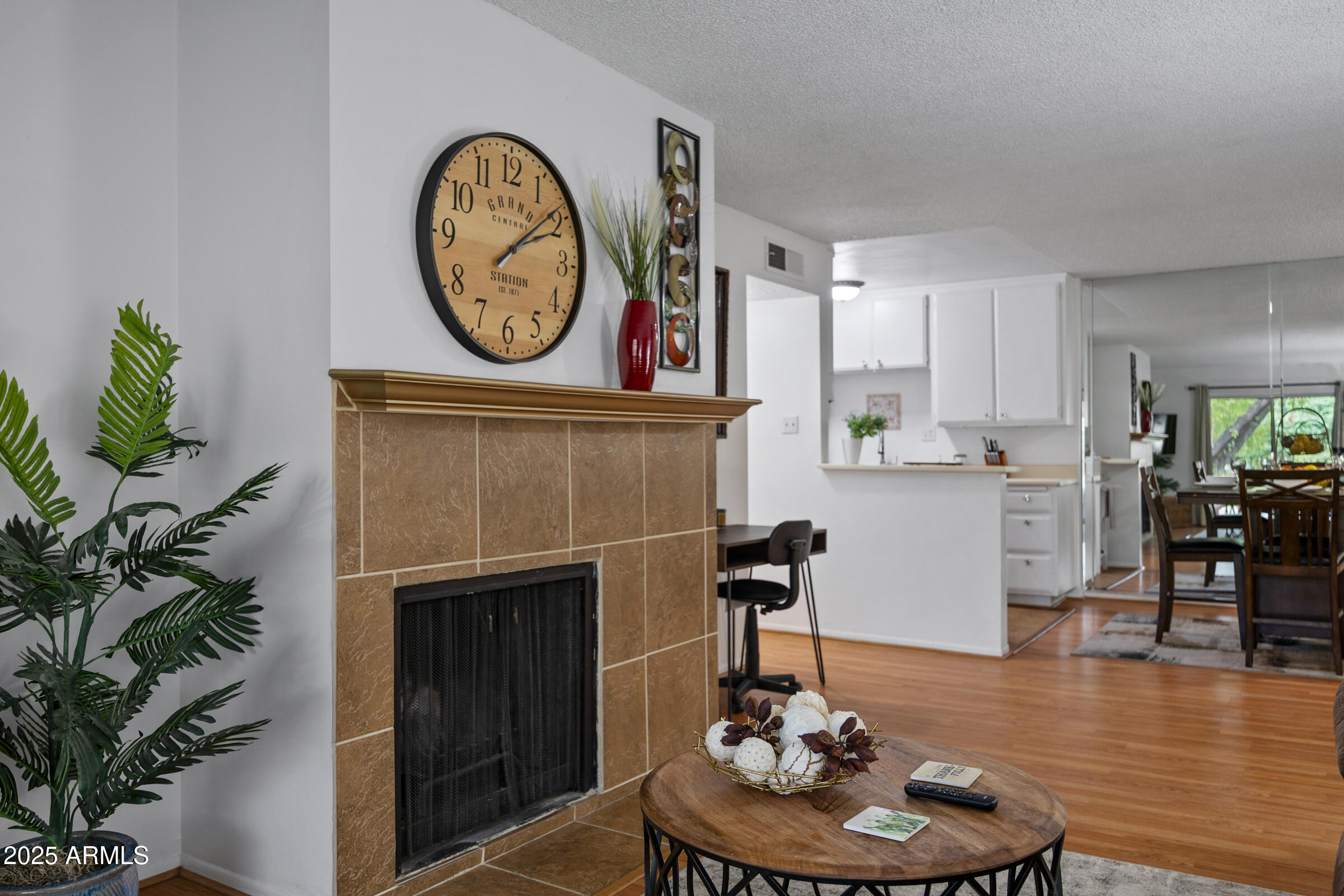 5525 East Thomas Road, Unit M11 Phoenix, AZ 85018 - Photo 13 of 39 a living room with furniture a clock and a fireplace