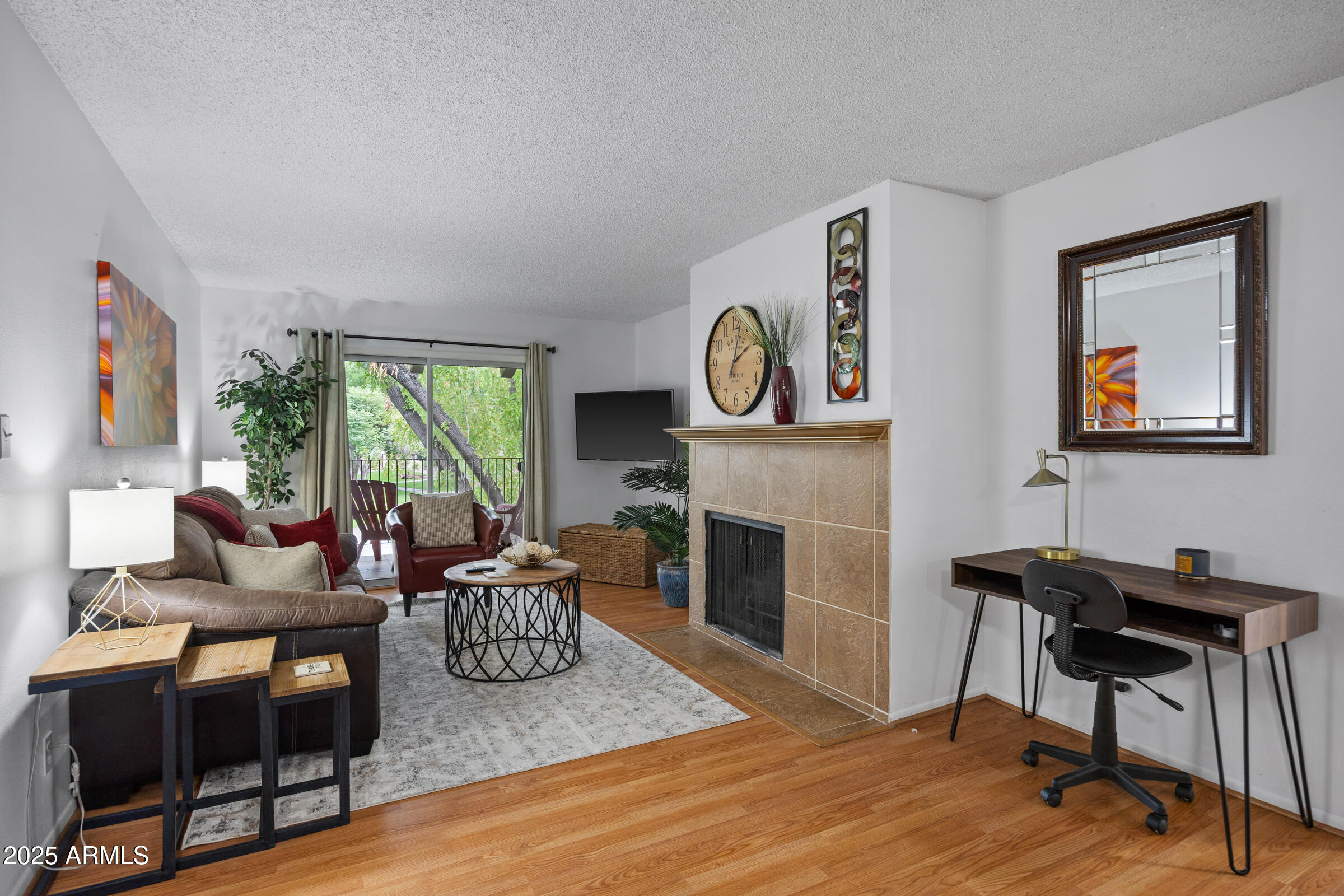 5525 East Thomas Road, Unit M11 Phoenix, AZ 85018 - Photo 3 of 39 a living room with furniture a fireplace and a large window