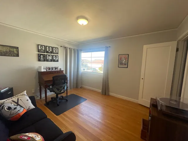 a view of a livingroom with workspace and a window