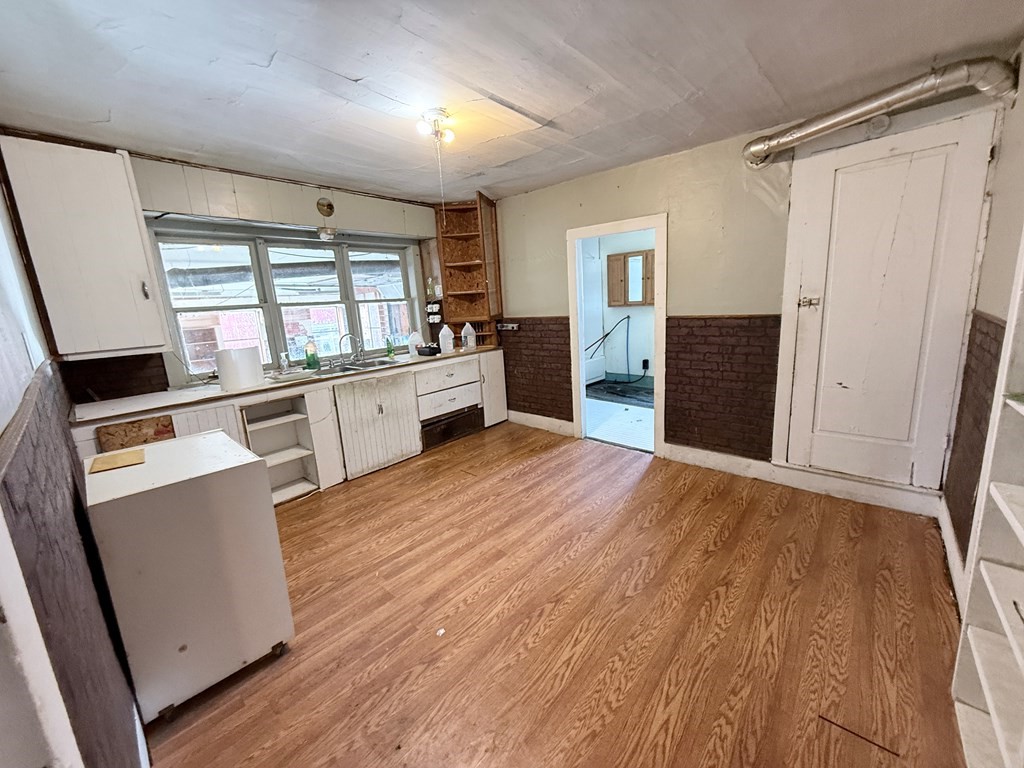 111 High Street Cooperstown, PA 16317 - Photo 2 of 46 a kitchen with granite countertop a refrigerator and wooden floor