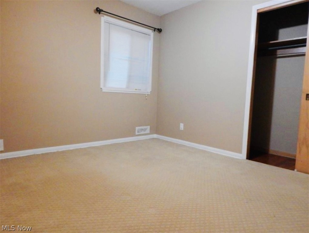 306 Richmond Road Cleveland, OH 44143 - Photo 9 of 17 Unfurnished bedroom with a closet and carpet flooring