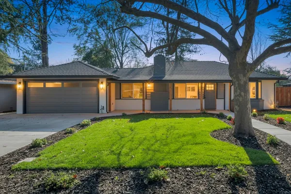 a view of house with backyard