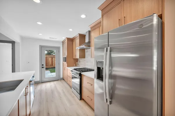 a large kitchen with stainless steel appliances granite countertop a large counter top stainless steel appliances and cabinets
