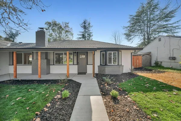 a front view of a house with garden