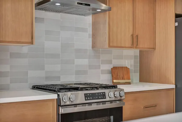 a stove top oven sitting inside of a kitchen