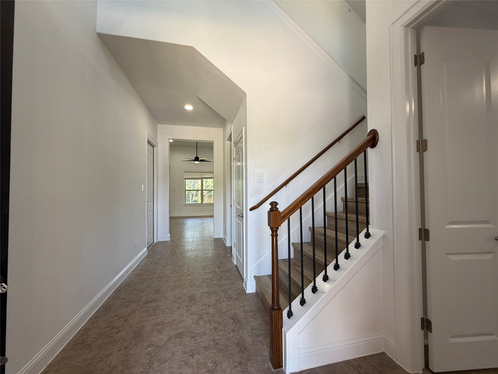 1512 Long Shadow Lane Georgetown, TX 78628 - Photo 3 of 19 a view of a hallway with wooden floor and staircase