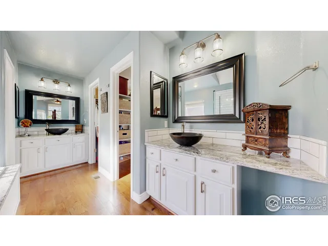 a en suite bathroom with a tub sink and mirror