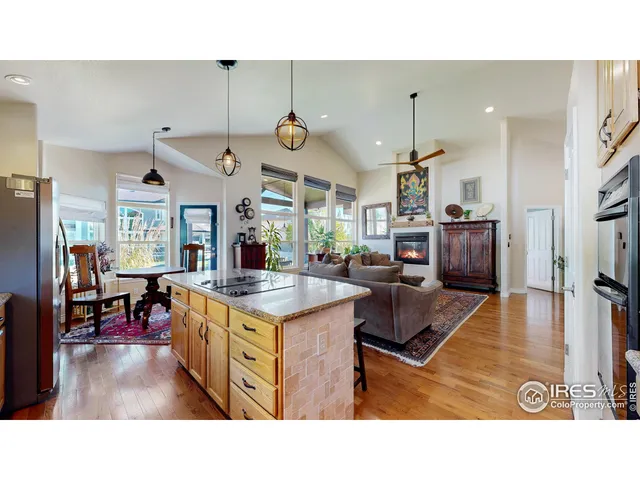 a kitchen with stainless steel appliances kitchen island granite countertop a sink and cabinets