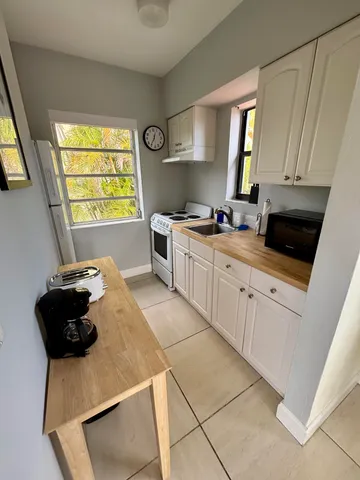 a view of a kitchen with a stove and a microwave