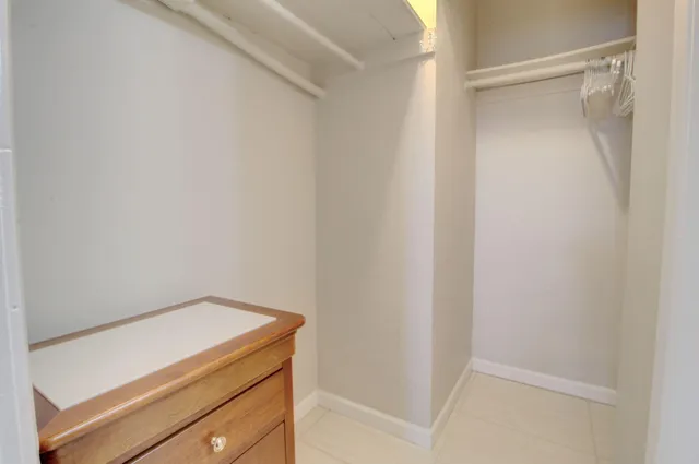 a bathroom with a sink a toilet a mirror and shower