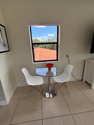 a kitchen with a sink a stove and white cabinets