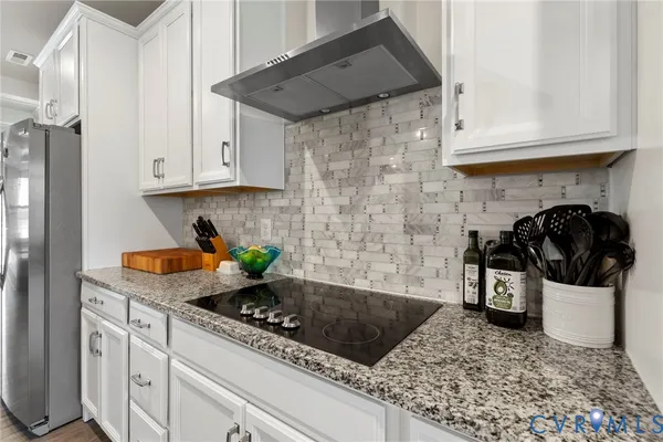 a kitchen with stainless steel appliances granite countertop a sink a stove and cabinets