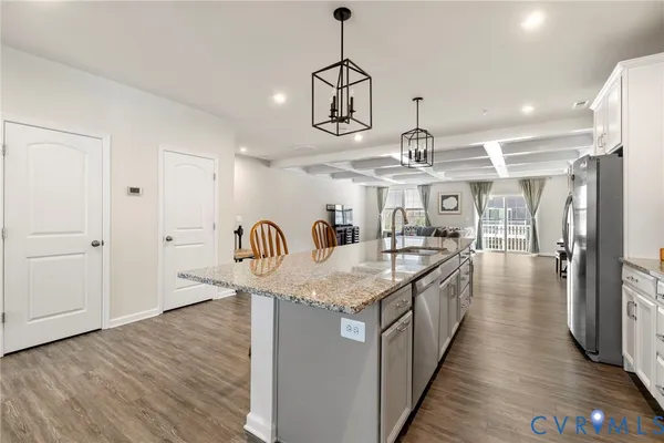 a kitchen with stainless steel appliances granite countertop a sink and refrigerator