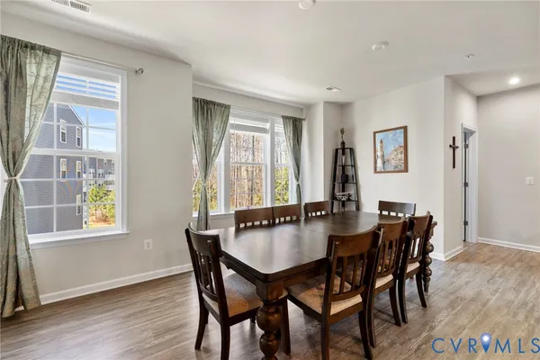 a dining room with furniture and window