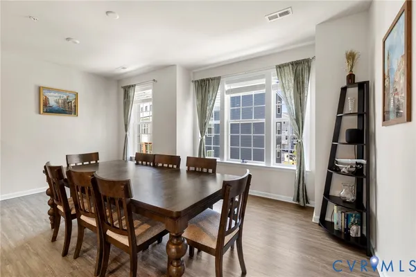 a view of a dining room with furniture and a book shelf