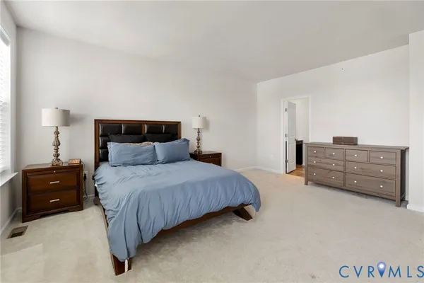 a bedroom with a bed and cabinets