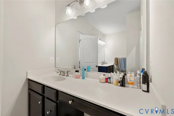 a bathroom with a sink a vanity and a mirror