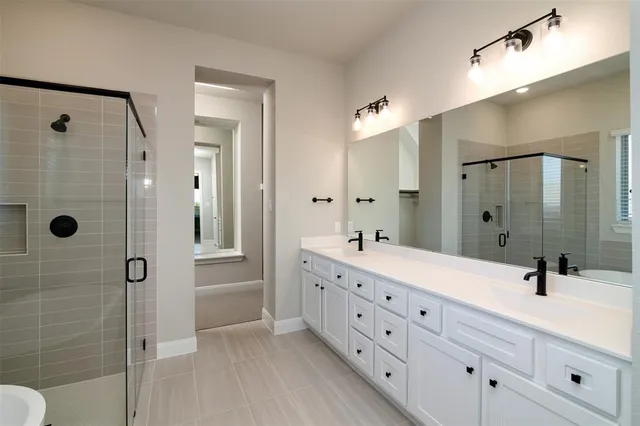 a bathroom with a double vanity sink mirror double and shower